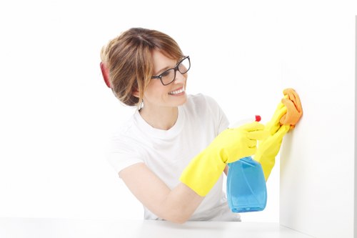 Cleaner using protective gloves during carpet care